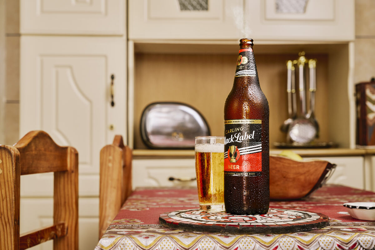 Still life of a Black Label quart and glass on a family kitchen table