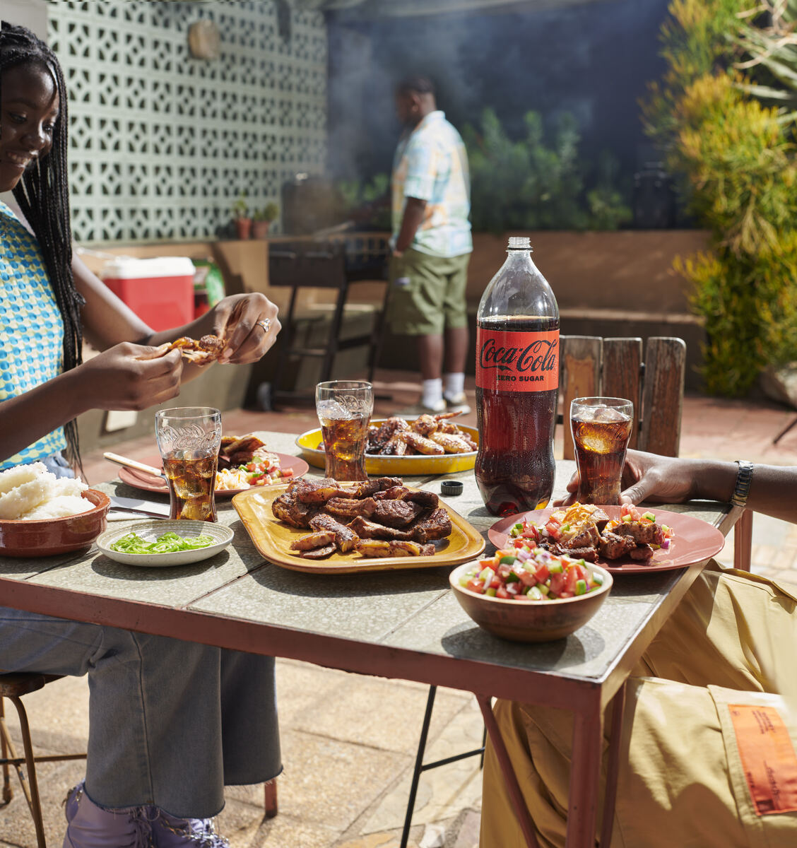 Backyard braai spread served with a two-litre Coca-Cola