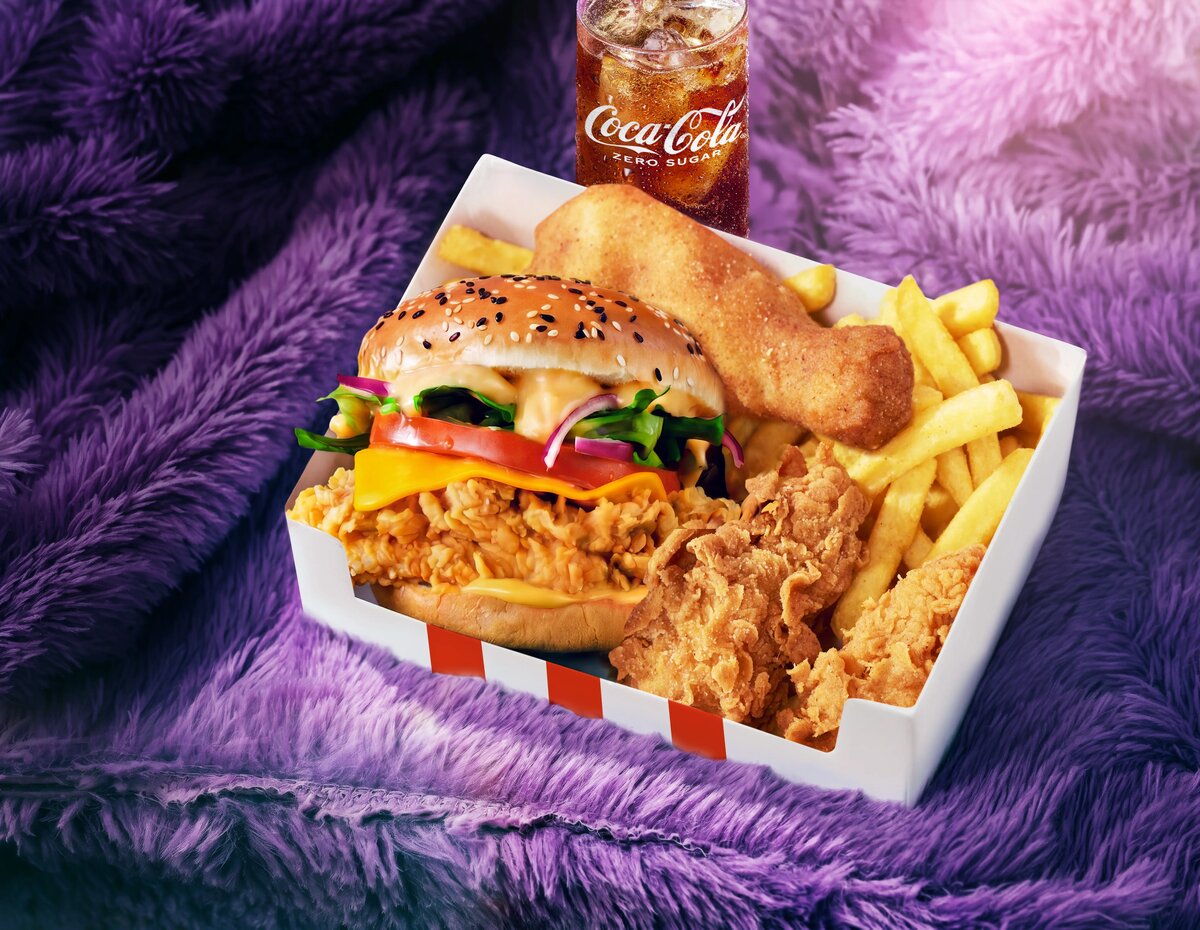 KFC box meal with burger, tenders and fries on a purple fur backdrop
